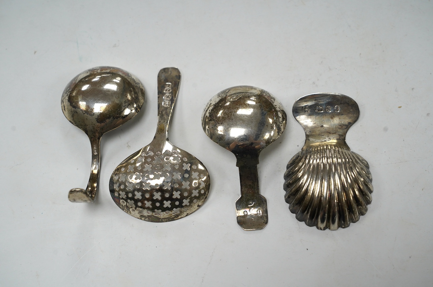 Four assorted silver caddy spoons, including Peter & Ann Bateman, London, 1793, 59mm, reeded handle, Joseph Wilmore?, Birmingham, 1807, pierced bowl, Alice & George Burrows, London, 1809 and curved handle John Lambe, Lon